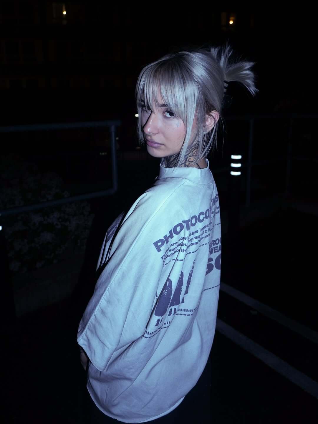 VSO Runway Tee in dirty vintage wash, showcasing its double-layered seamless design, worn stylishly outdoors at night.